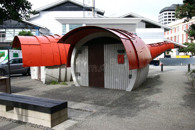 Red scaled and paneled facade in undulation of Kumutoto Toilet on Synergy Plaza on Queens Wharf, Wellington CBD, New Zealand