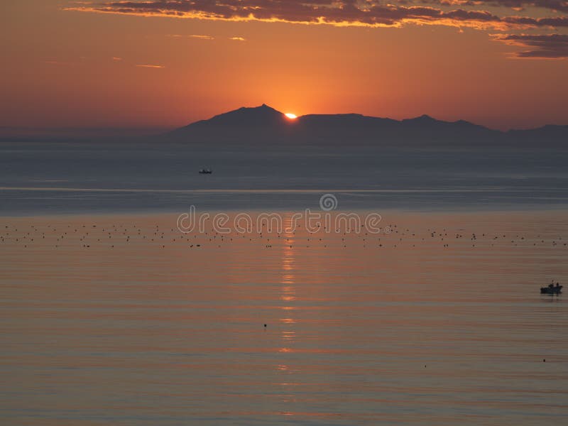 Kunashiri island and the rising sun viewed from Rausu,Nemuro strait, Hokkaido, Japan