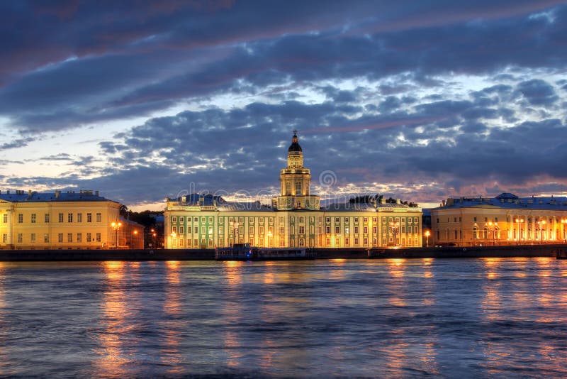 Kunstkammer (Kunstkamera) Museum on the Vasilevskiy Island from across the Neva River in Saint Petersburg, Russia at twilight. Kunstkammer (Kunstkamera) Museum on the Vasilevskiy Island from across the Neva River in Saint Petersburg, Russia at twilight.