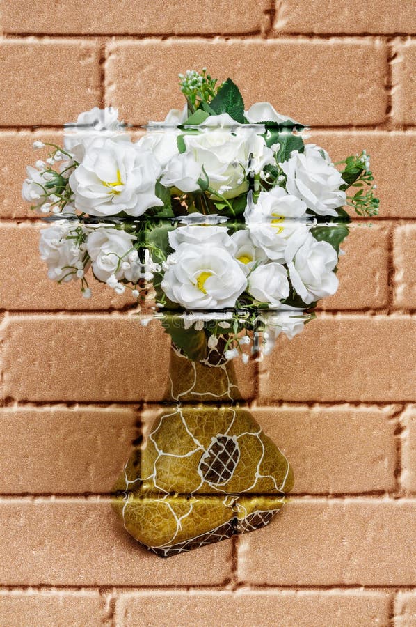 White roses, artificial flowers of fabric on a blurred copper-coloured background, in a decorative vase,imitation graffiti,mural on a brick wall,imitation painting. White roses, artificial flowers of fabric on a blurred copper-coloured background, in a decorative vase,imitation graffiti,mural on a brick wall,imitation painting