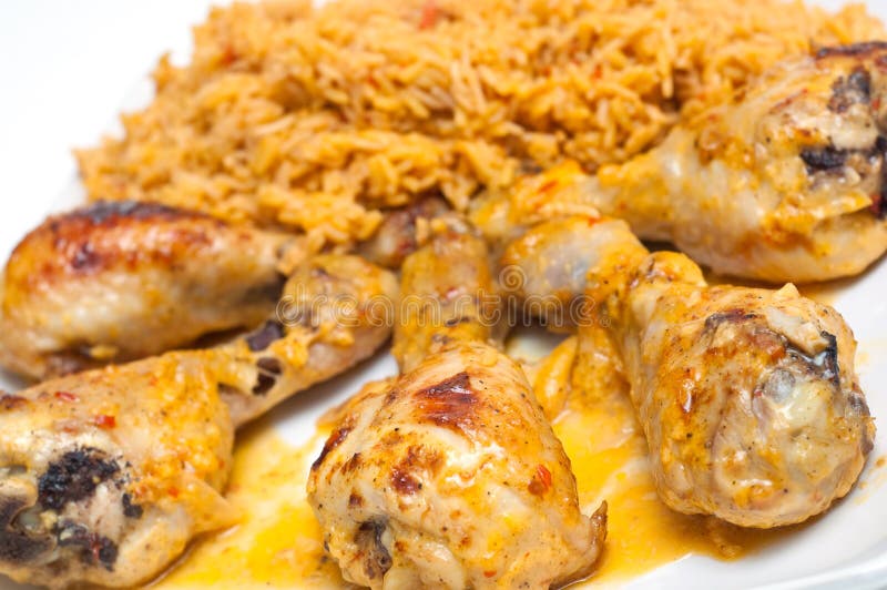 Chicken drumbsticks and mexican rice on white. Chicken drumbsticks and mexican rice on white