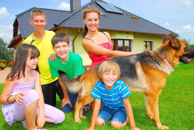 Siblings with their dog by home. Siblings with their dog by home.