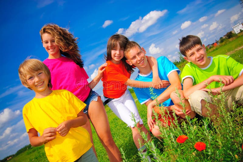 Siblings hold together on sunny day outside. Siblings hold together on sunny day outside.