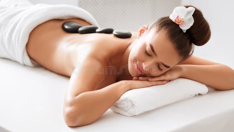Kuuroord - 7 Vrouw die van hete steenmassage genieten stock foto Kuuroord - 7 Vrouw die van hete steenmassage genieten stock foto