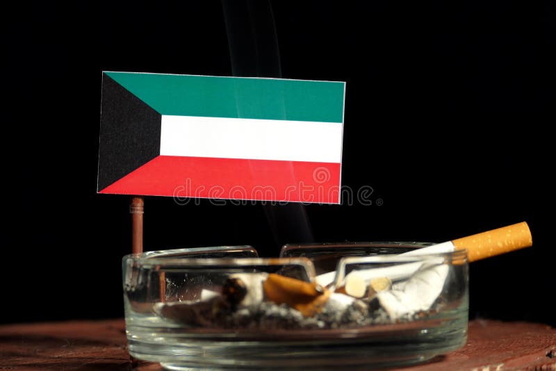 Kuwaiti Flag with Burning Cigarette in Ashtray on Black Stock Image