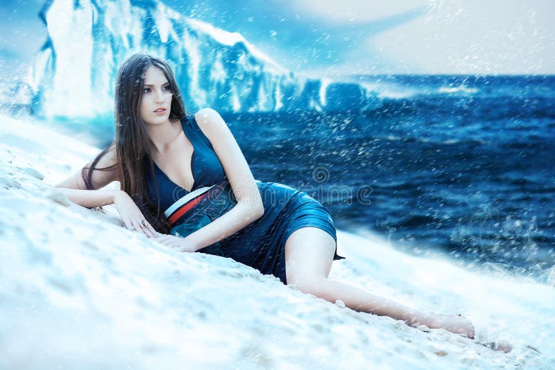 Woman in dress on the snowy beach and iceberg. Woman in dress on the snowy beach and iceberg