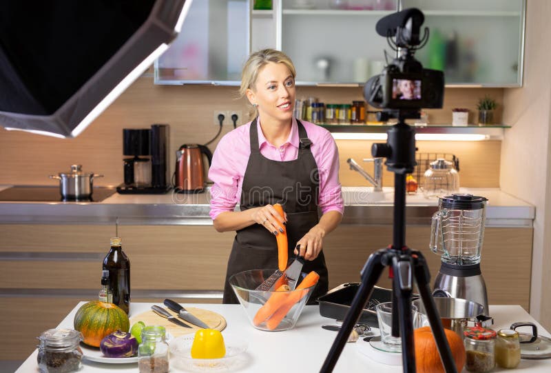 Kvinna som gör att laga mat vlog som antecknar sig på kamera royaltyfri foto