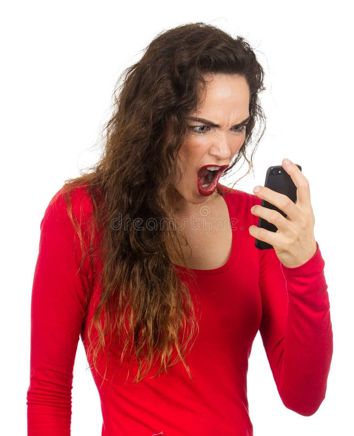 A very angry, annoyed and frustrated woman screaming at her phone in rage. Isolated on white. A very angry, annoyed and frustrated woman screaming at her phone in rage. Isolated on white.