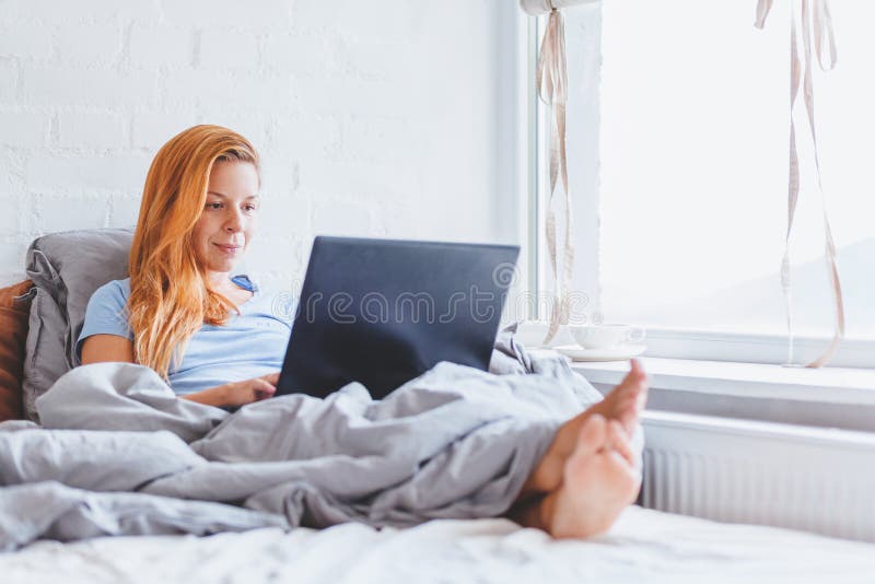 Kvinna som tidigt på morgonen arbetar i säng på bärbara datorn royaltyfri foto Kvinna som tidigt på morgonen arbetar i säng på bärbara datorn royaltyfri foto