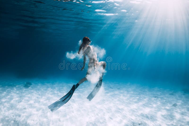 Kvinnafreediver med fena och vit sand över det sandiga havet Undervattens- Freediving fotografering för bildbyråer Kvinnafreediver med fena och vit sand över det sandiga havet Undervattens- Freediving fotografering för bildbyråer