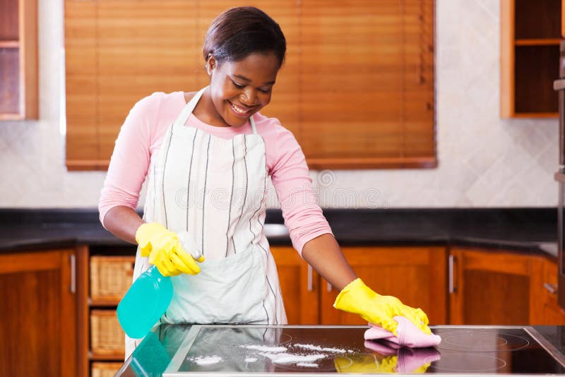 Pretty young african woman doing house chores. Pretty young african woman doing house chores