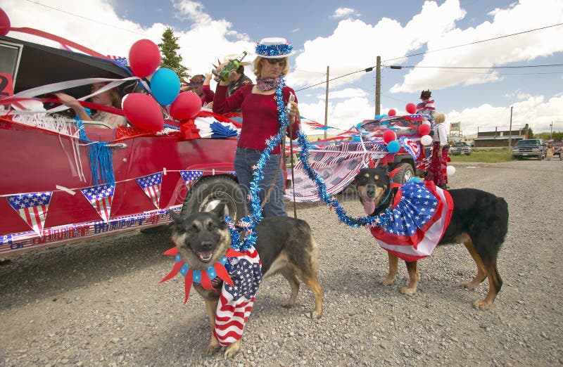 Woman with patriotic dogs at Fourth of July Parade, in Lima Montana. Woman with patriotic dogs at Fourth of July Parade, in Lima Montana
