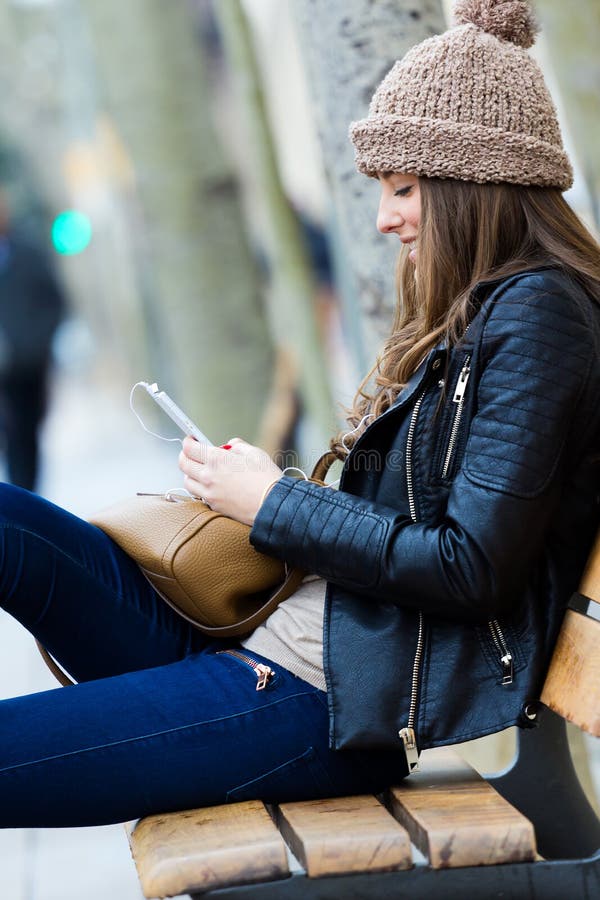 Kvinnashopping i staden med hans smartphone royaltyfri foto Kvinnashopping i staden med hans smartphone royaltyfri foto