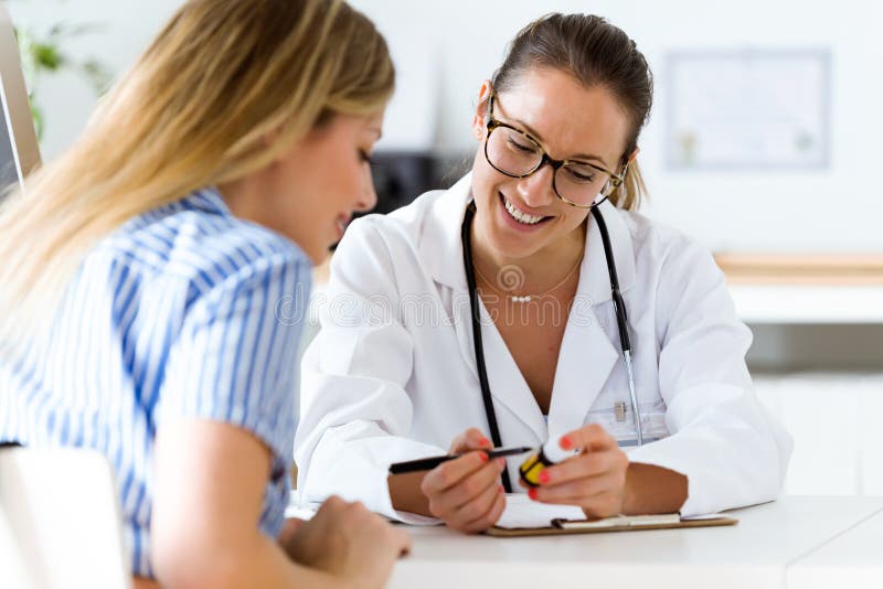 Kvinnlig doktor som ordinerar läkarbehandlingen för patient fotografering för bildbyråer