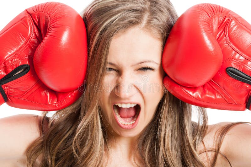 Female model wearing red boxing gloves screaming or shouting expressing madness or angry. Female model wearing red boxing gloves screaming or shouting expressing madness or angry