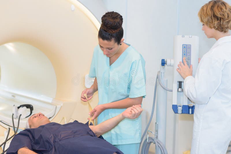 Radiologic technician female patient lying on a ct scan bed. Radiologic technician female patient lying on a ct scan bed