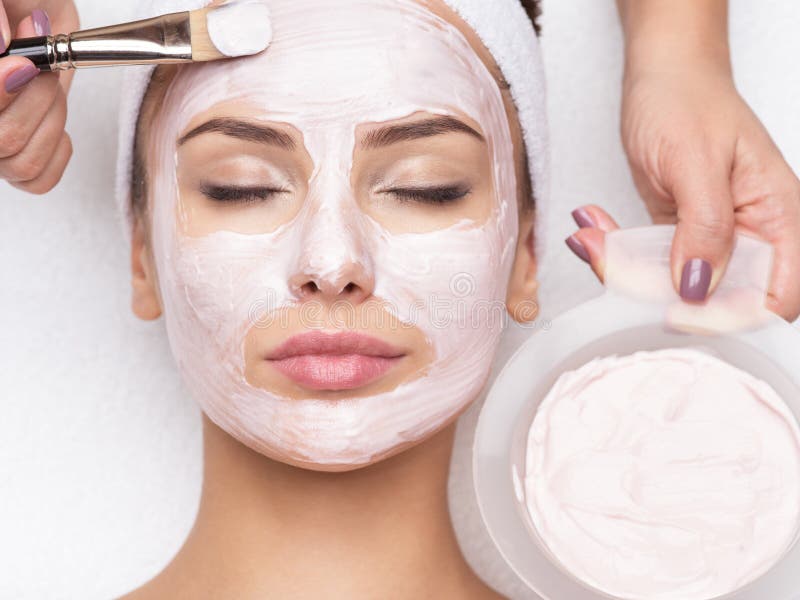 Young beautiful woman receiving  facial mask in spa beauty salon. Young beautiful woman receiving  facial mask in spa beauty salon