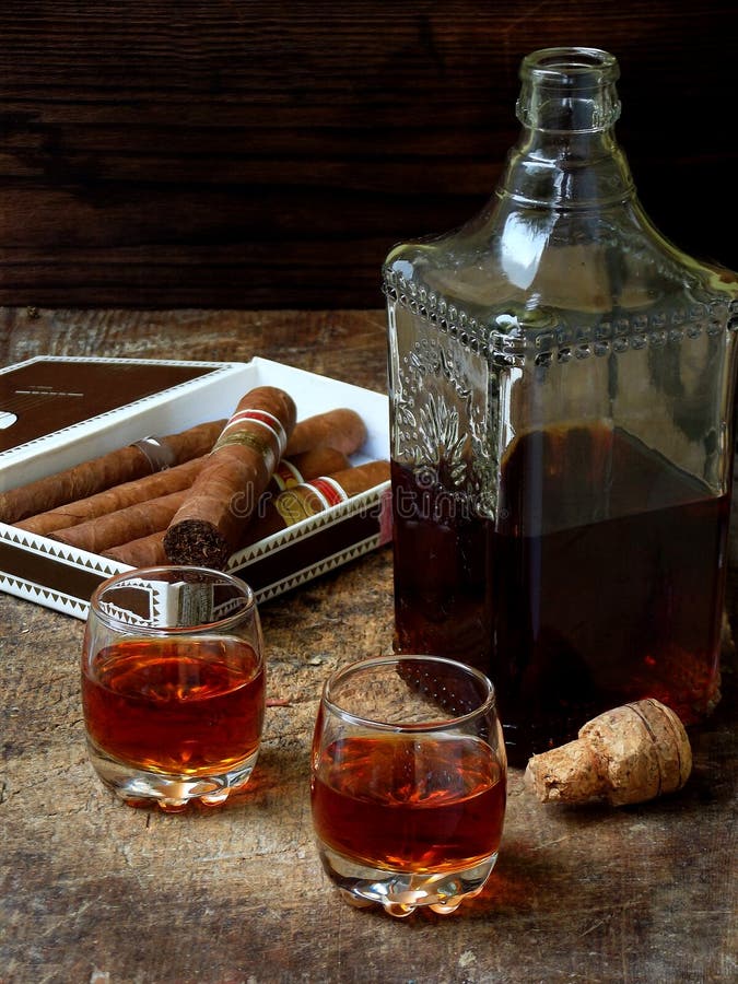 Quality cigars and cognac on an old wooden table. Quality cigars and cognac on an old wooden table