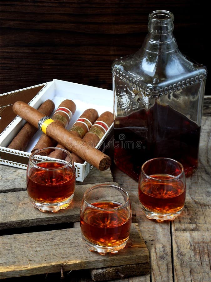Quality cigars and cognac on an old wooden table. Quality cigars and cognac on an old wooden table