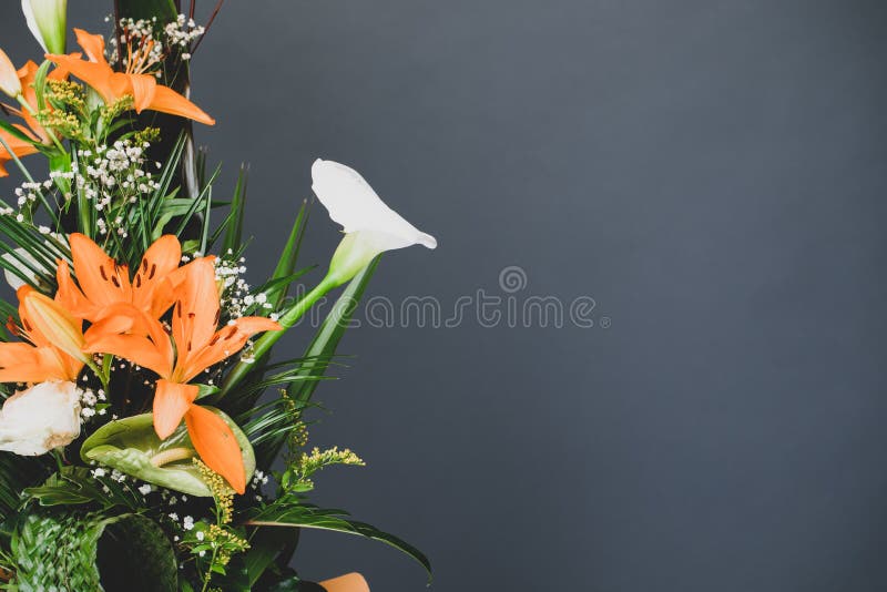 Flower arrangement bouquet to the side with grey studio background copy space. Floral concept background with gray negative space for text. Flower arrangement bouquet to the side with grey studio background copy space. Floral concept background with gray negative space for text.