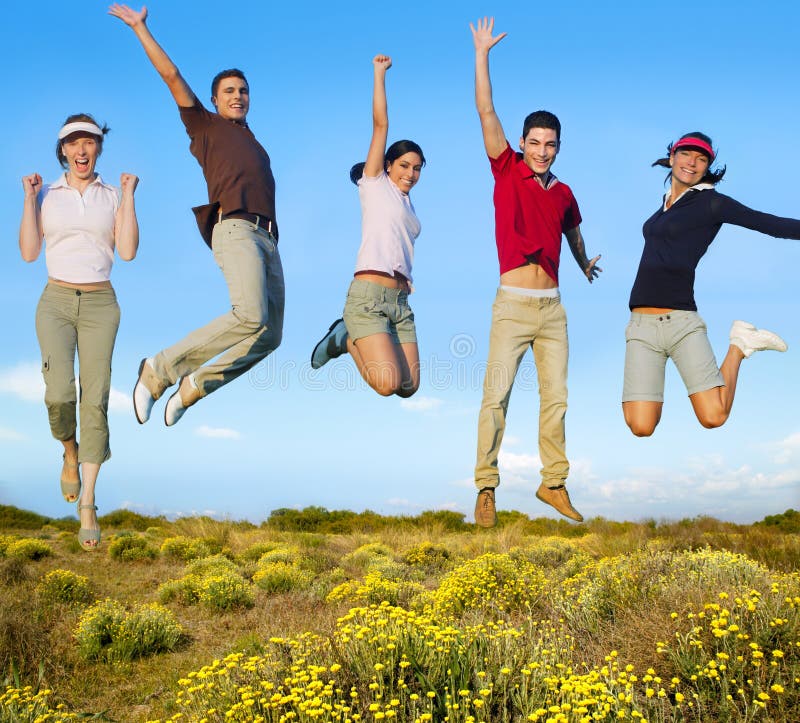 Jumping young people happy group in yellow flowers field. Jumping young people happy group in yellow flowers field