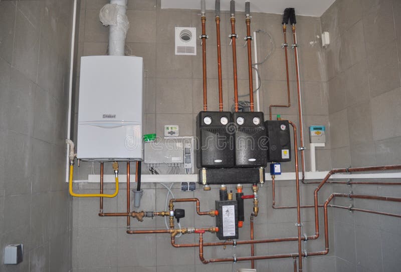 Boiler room under construction and installation. Natural gas boiler and solar water heater system in house room stock images Boiler room under construction and installation. Natural gas boiler and solar water heater system in house room stock images