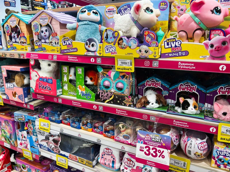 Kyiv, Ukraine - February 09, 2025: Colorful store display of interactive plush toys for children. Kyiv, Ukraine - February 09, 2025: A selection of various interactive plush toys displayed on a colorful storefront shelf