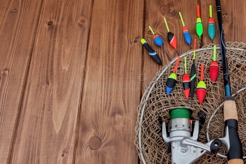 Kyiv, Ukraine- May 15, 2019 Fishing tackle - fishing rod fishing float and lures on beautiful blue wooden background, copy space