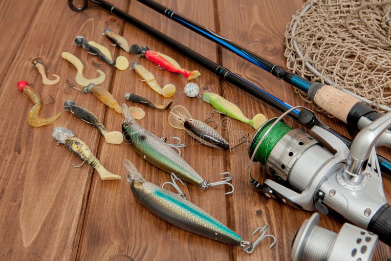 Kyiv, Ukraine- May 15, 2019 Fishing tackle - fishing spinning, hooks and lures on wooden background with copy space