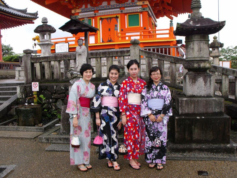 Four women dressed in traditional colorful kimono in a Kyoto temple royalty free stock photos