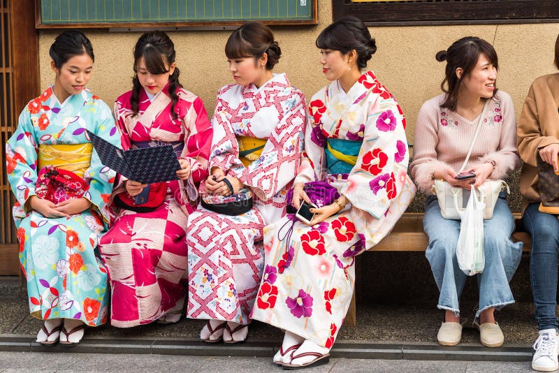 KYOTO, JAPAN - NOVEMBER 7, 2017: a Group of Girls in a Kimono Sit on a ...