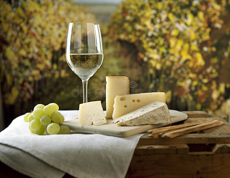 Three kinds of french cheese and a glass of white wine. Three kinds of french cheese and a glass of white wine