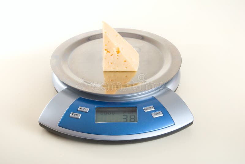 Pyramidal piece of cheese on electronic scales. Pyramidal piece of cheese on electronic scales