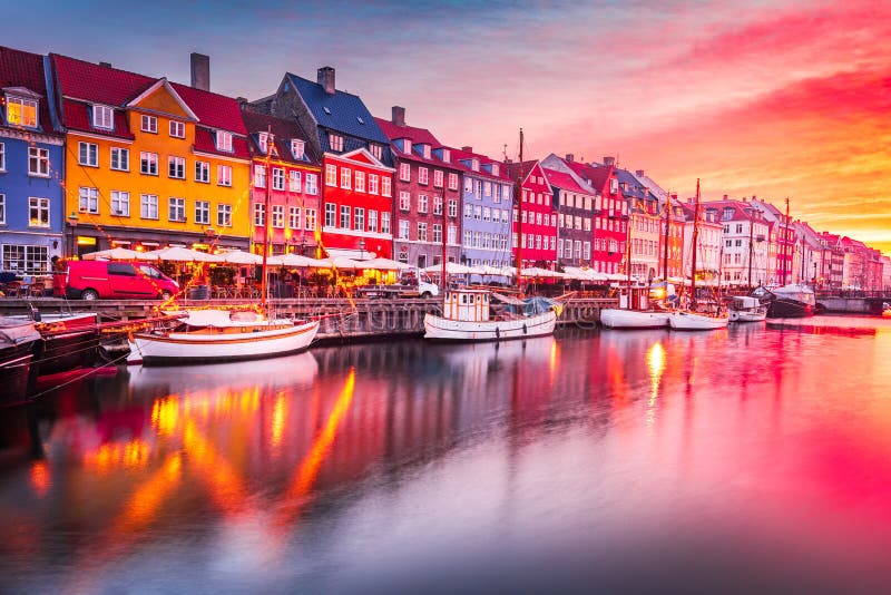 Copenhage, Denmark. Experience the breathtaking beauty of Nyhavn canal at sunrise, with its iconic colorful buildings and serene water reflections. Copenhage, Denmark. Experience the breathtaking beauty of Nyhavn canal at sunrise, with its iconic colorful buildings and serene water reflections