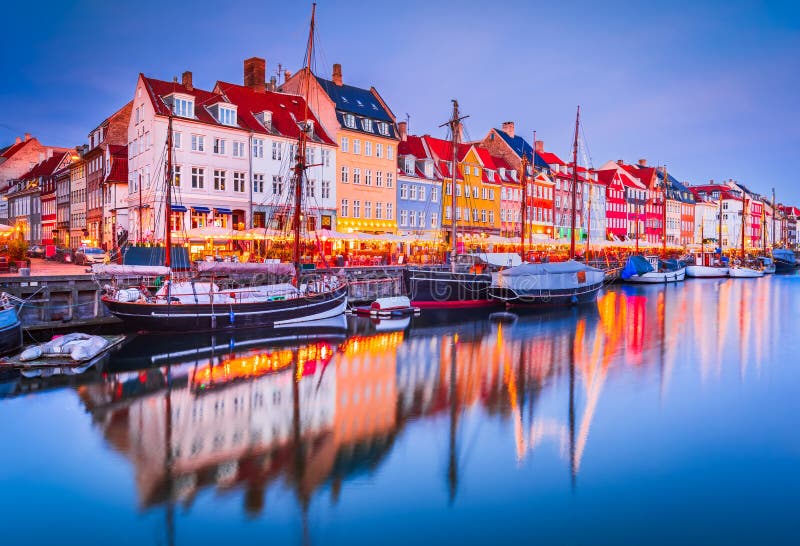 Charm of Copenhagen, Denmark at Nyhavn. Iconic canal, colorful morning twilight with breathtaking water reflections. Charm of Copenhagen, Denmark at Nyhavn. Iconic canal, colorful morning twilight with breathtaking water reflections