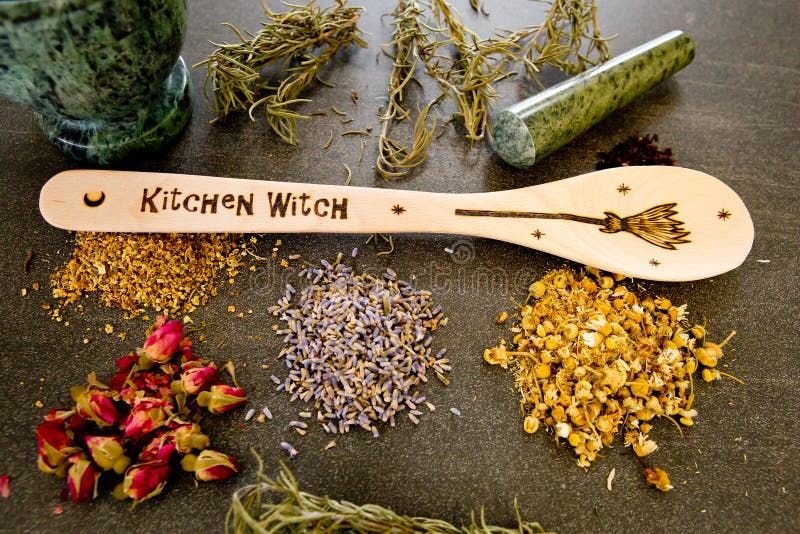 Kitchen Witch - spoon with dried mixed Herbs on gray / grey slate background - chamomile, hibiscus, arnica,  elder flower, rose bud and rosemary. Kitchen Witch - spoon with dried mixed Herbs on gray / grey slate background - chamomile, hibiscus, arnica,  elder flower, rose bud and rosemary