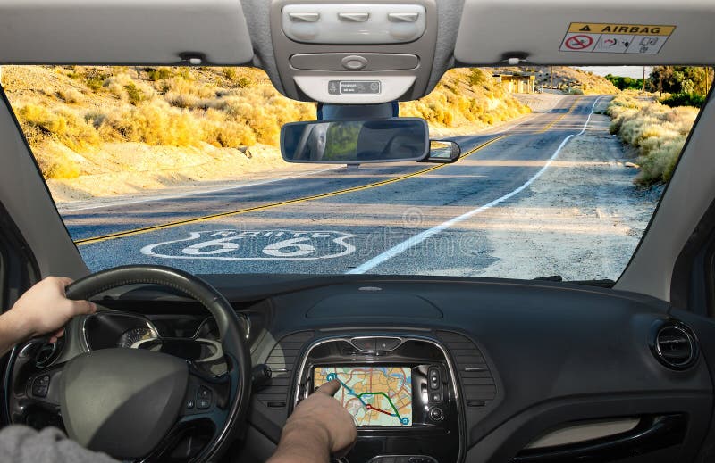 Driving a car while using the touch screen of a GPS navigation system on the Historic Route 66 in California, USA. Driving a car while using the touch screen of a GPS navigation system on the Historic Route 66 in California, USA