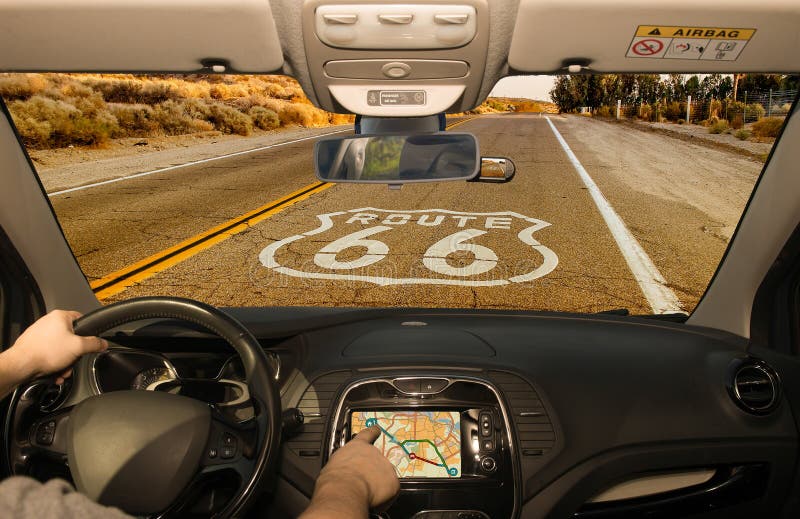 Driving a car while using the touch screen of a GPS navigation system on the Historic Route 66 in California, USA. Driving a car while using the touch screen of a GPS navigation system on the Historic Route 66 in California, USA