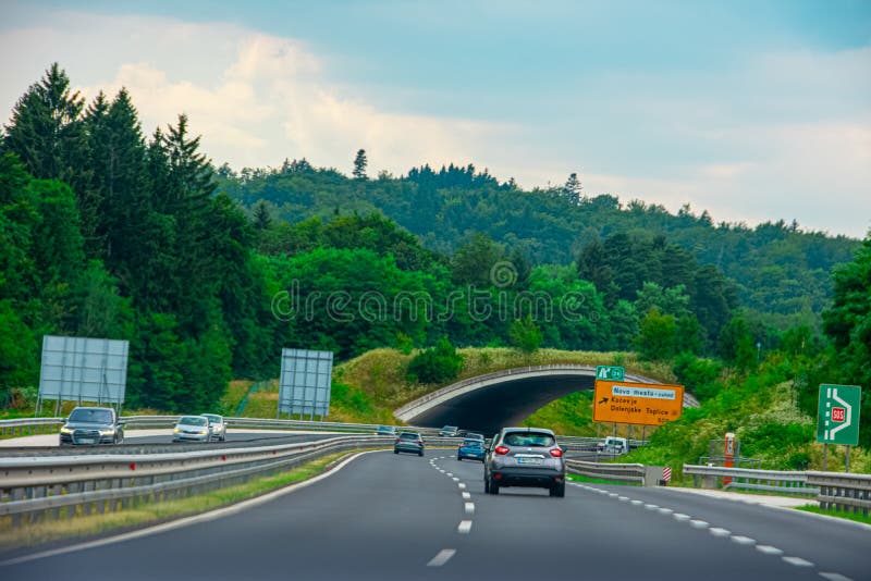 Two lane highway through the beautiful natural landscape and overpass for wild animals in country of Slovenia , 2019.07.26. Two lane highway through the beautiful natural landscape and overpass for wild animals in country of Slovenia , 2019.07.26