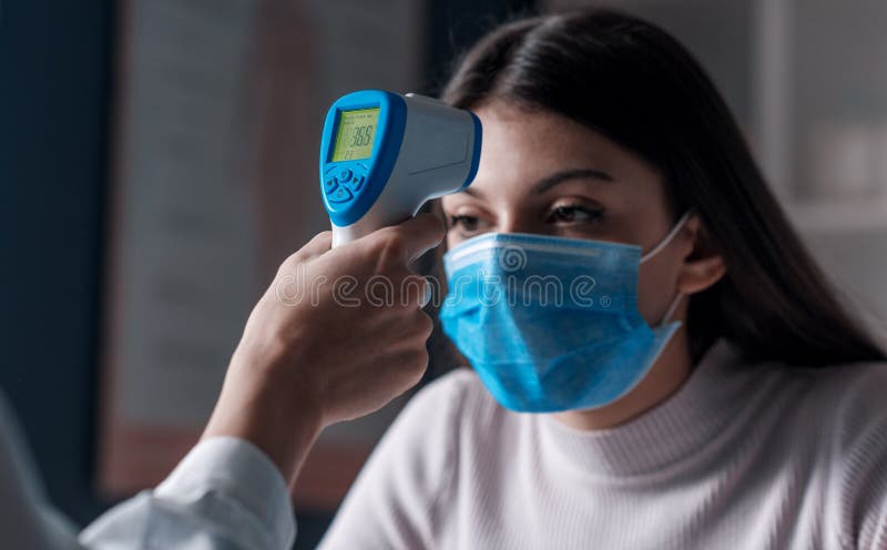 Body temperature check: doctor measuring temperature using a infrared thermometer gun. Body temperature check: doctor measuring temperature using a infrared thermometer gun