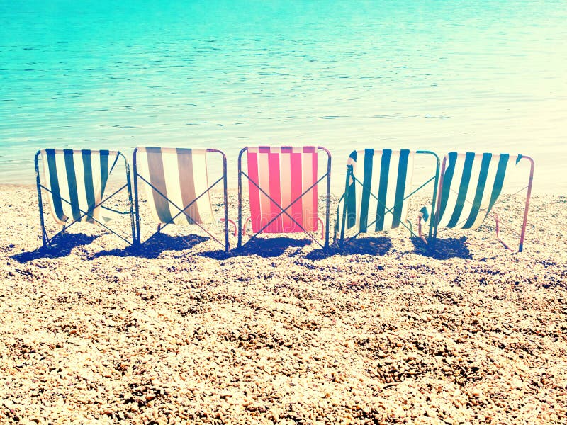 Kühlen Sie auf Strand mit Retro- Streifensonnenbett