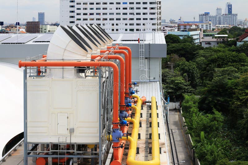 Cooling Tower on the Roof Deck with Colorful piping and valves. Cooling Tower on the Roof Deck with Colorful piping and valves