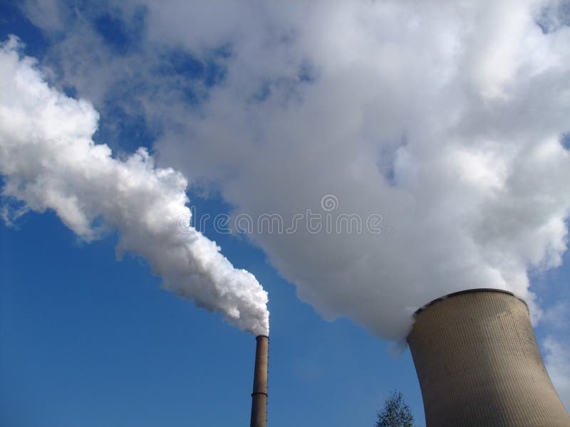 Steam geting out of a cooling tower of a coal power plant into blue sky. Steam geting out of a cooling tower of a coal power plant into blue sky