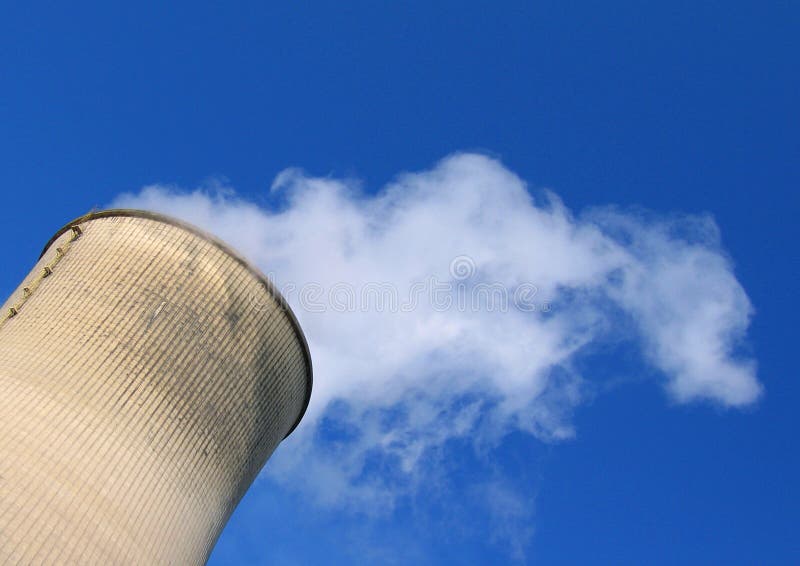 Steam going out of a cooling tower of a coal power plant into blue sky. Steam going out of a cooling tower of a coal power plant into blue sky