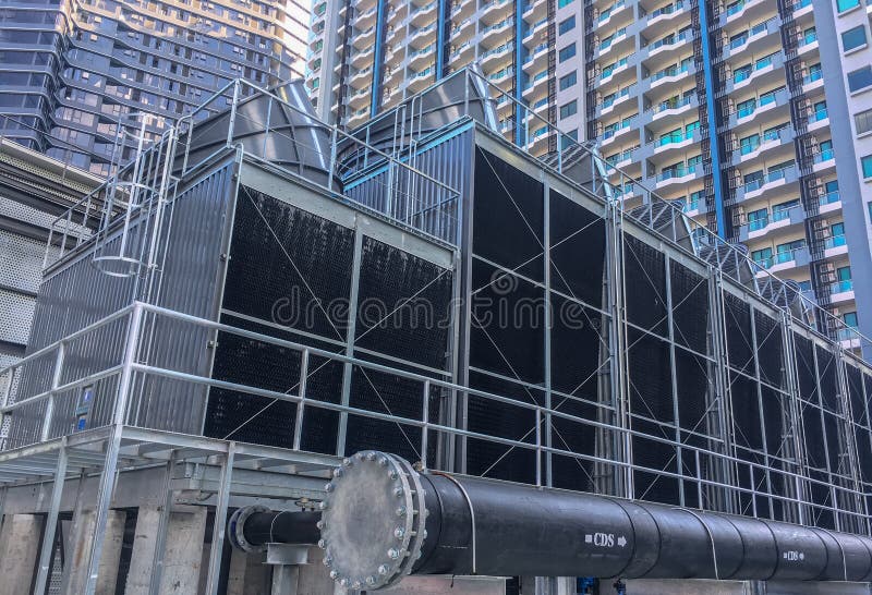 cooling towers with a pipe install on the rooftop of building. cooling towers with a pipe install on the rooftop of building