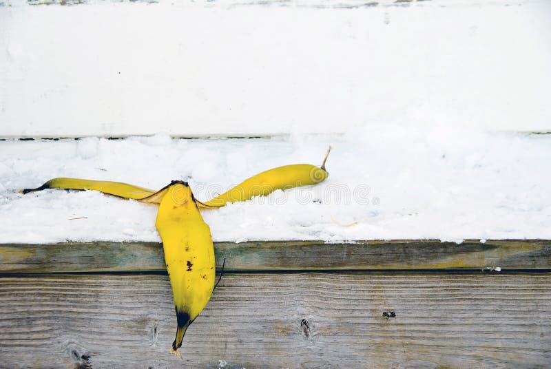 A banana peel on snow covered steps. A banana peel on snow covered steps.