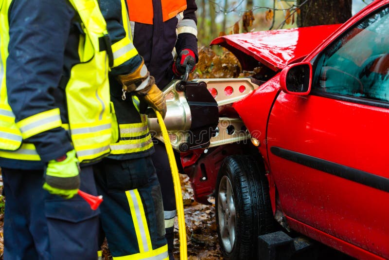 Accident - Fire brigade rescues accident Victim of a car using a hydraulic rescue tool. Accident - Fire brigade rescues accident Victim of a car using a hydraulic rescue tool