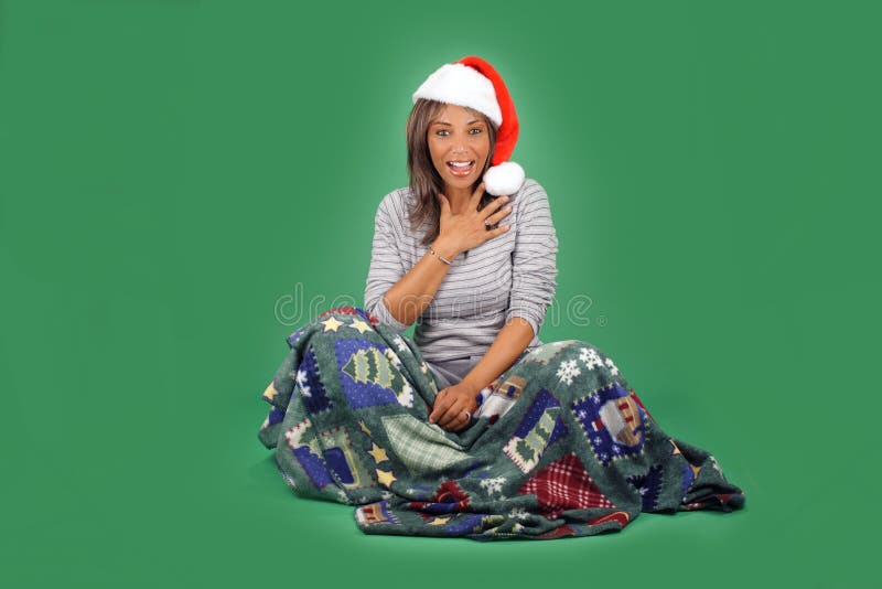 A lovely mature black woman wearing a Santa's helper hat, sits wrapped in a cozy holiday / winter themed blanket. Her facial expression and body language indicates great excitement, as if to say, I can't believe you did / got that for me! There's plenty of blank space for inserting text, logos, graphics, etc. A lovely mature black woman wearing a Santa's helper hat, sits wrapped in a cozy holiday / winter themed blanket. Her facial expression and body language indicates great excitement, as if to say, I can't believe you did / got that for me! There's plenty of blank space for inserting text, logos, graphics, etc.