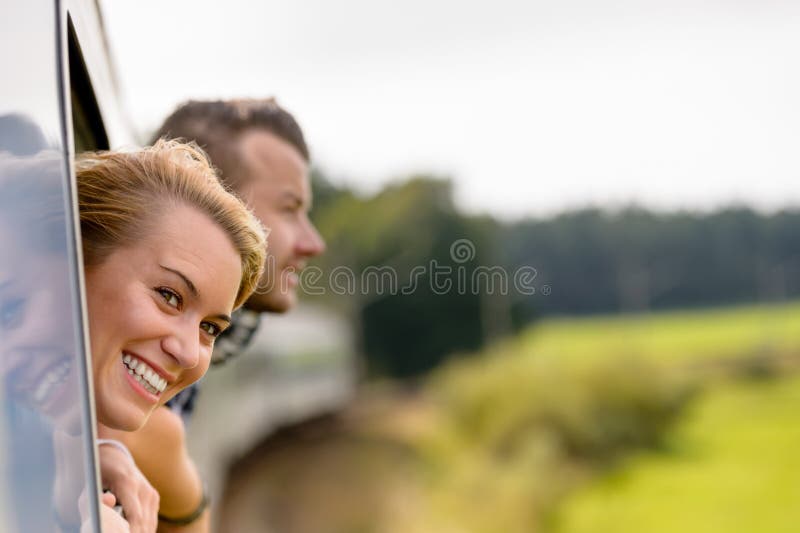 Couple with heads out the train window excited women man. Couple with heads out the train window excited women man