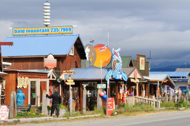 A view of visitors and tourists checking out some of the tour offices and gift shops along the world famous Homer Spit in Homer, Alaska at the end of Kenai Peninsula and surrounded by Kachemak Bay. A common summer cruise ship port of call, located on the very end of the Kenai Peninsula and part of the Pacific Ocean Ring of Fire, Homer is famous for commercial and recreational fishing, particularly halibut, outdoor recreation opportunities, and its eclectic artist vibe and unique arts and crafts is popular with both Alaskans and tourists alike. A view of visitors and tourists checking out some of the tour offices and gift shops along the world famous Homer Spit in Homer, Alaska at the end of Kenai Peninsula and surrounded by Kachemak Bay. A common summer cruise ship port of call, located on the very end of the Kenai Peninsula and part of the Pacific Ocean Ring of Fire, Homer is famous for commercial and recreational fishing, particularly halibut, outdoor recreation opportunities, and its eclectic artist vibe and unique arts and crafts is popular with both Alaskans and tourists alike.